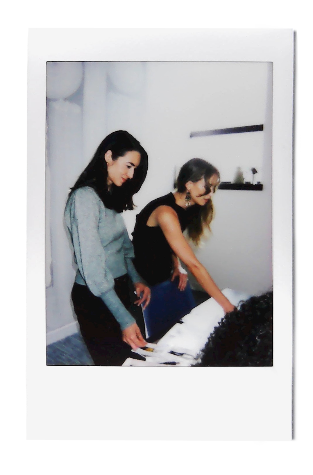 Polaroid of two women working together at the mes° studio.