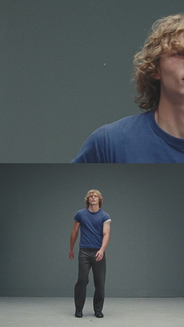 Portrait film of Anthony, a cast member with curly blonde hair, in the studio.