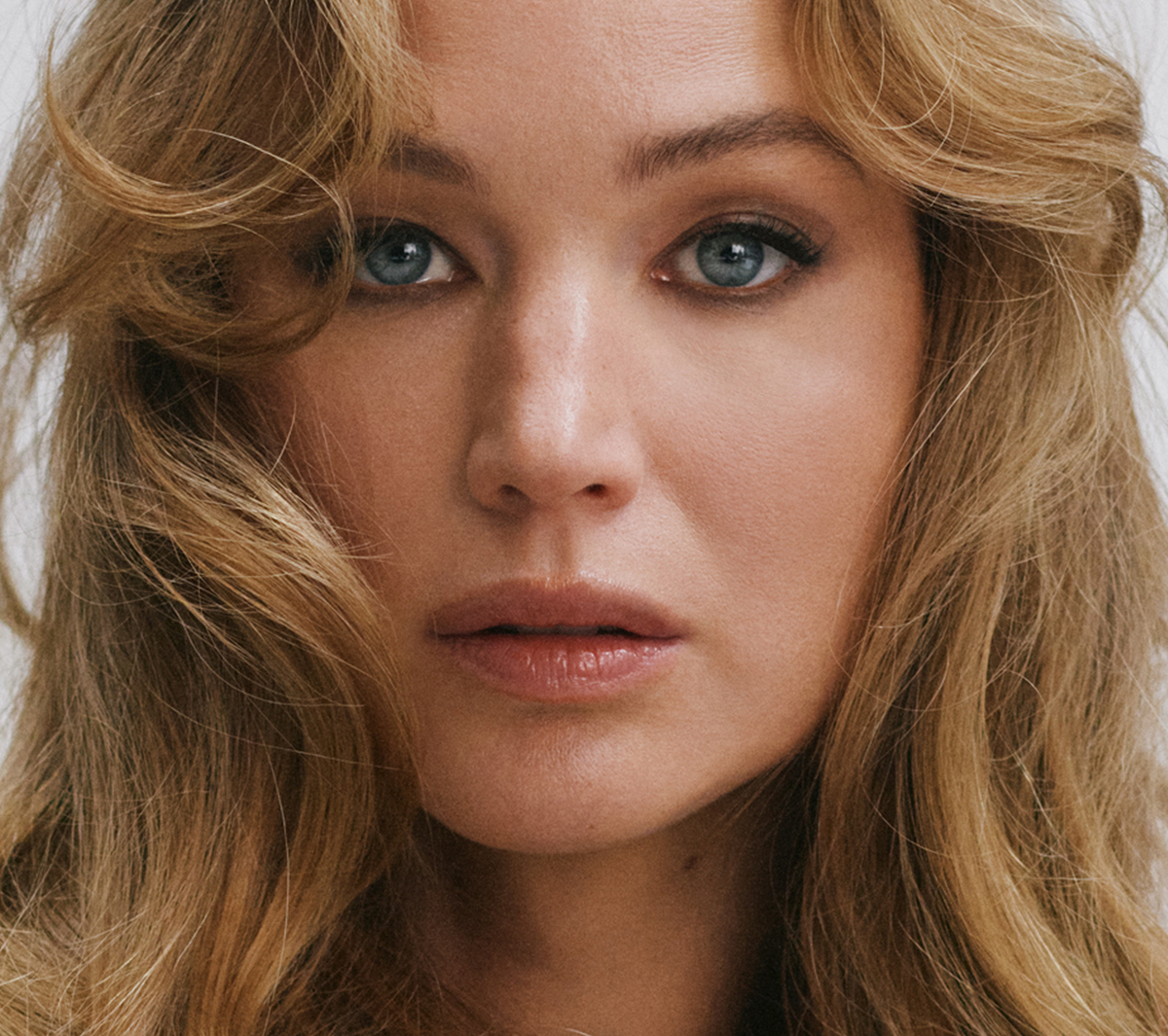 Close-up of Jennifer Lawrence's face framed by tousled blonde hair.